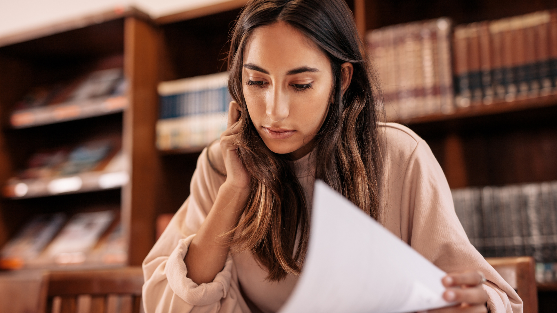 Student studying with English materials in library setting