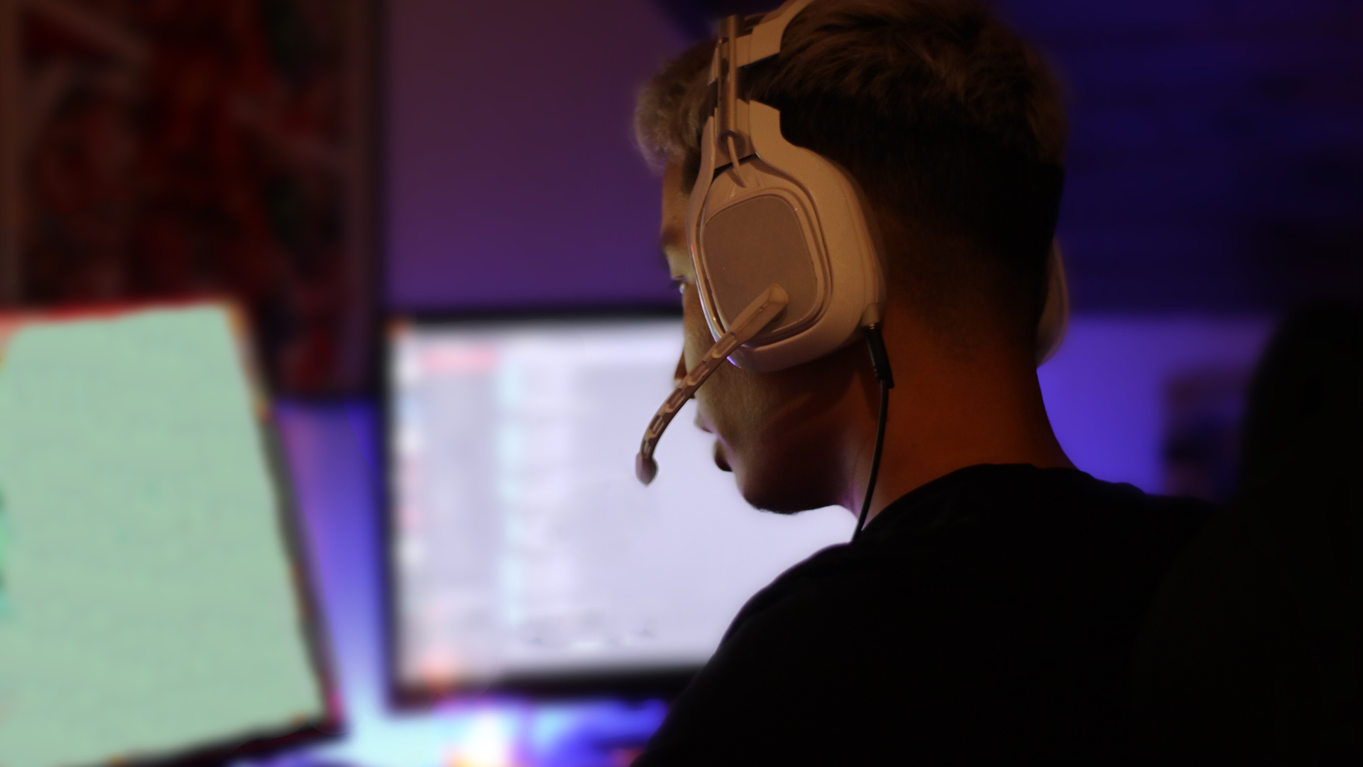 Gamer wearing headset playing online games to practice English with other players