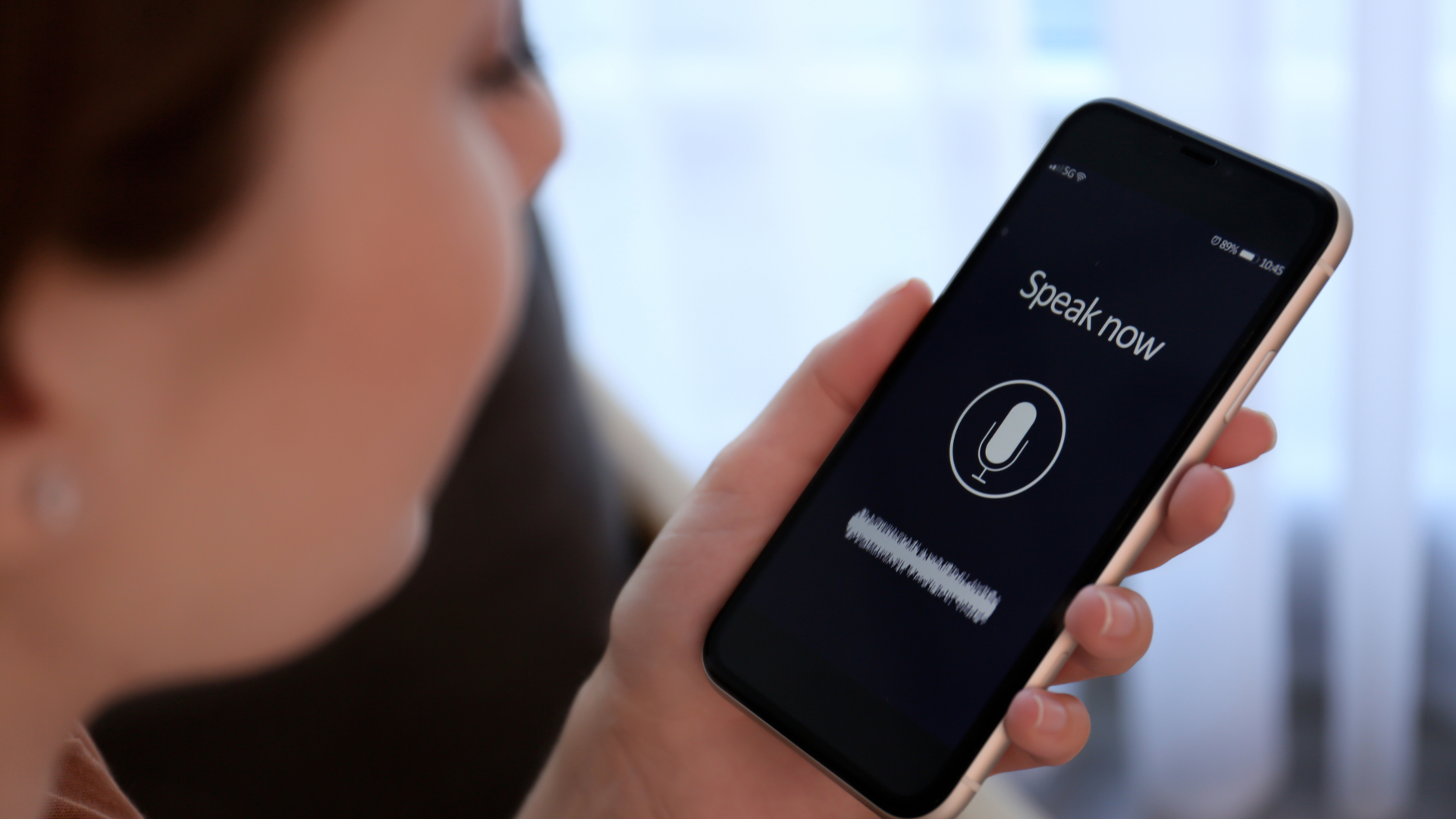 Person using voice recording app on smartphone to practice English speaking